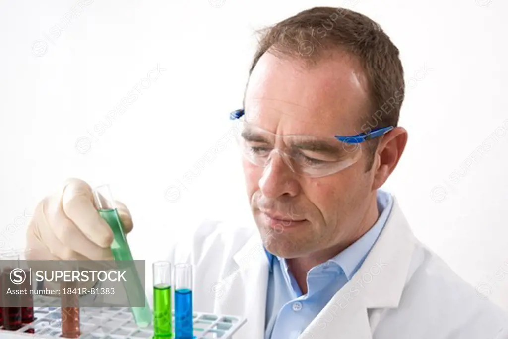 Scientist examining with test tubes