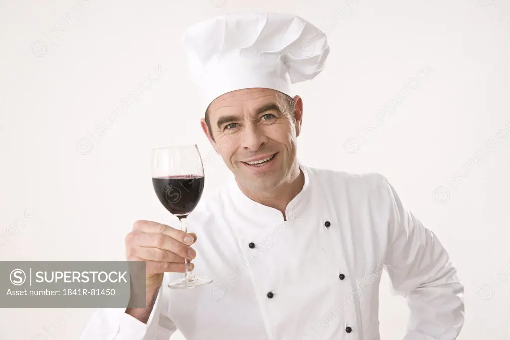 Chef holding glass of red wine