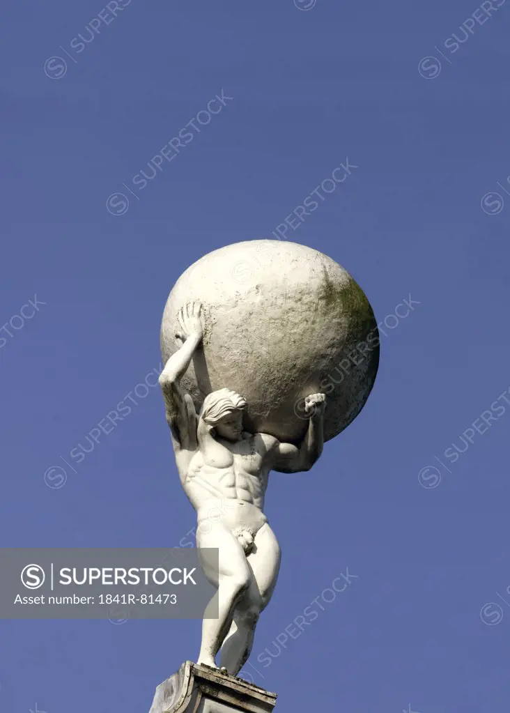Low angle view of statue of man carrying globe