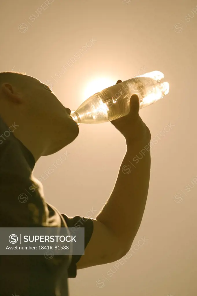 Low angle view of man drinking water from bottle