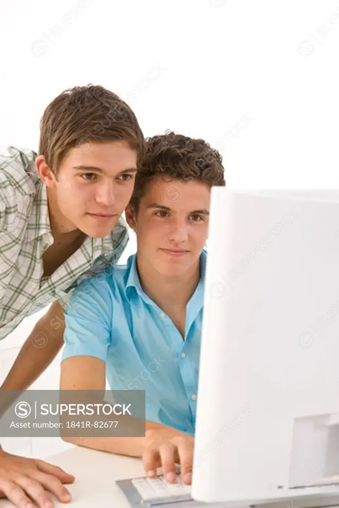 Two boys in front of a computer
