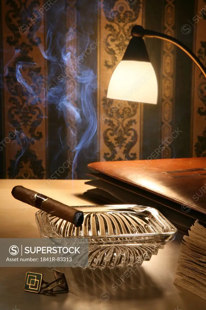 Unlit cigar in ashtray on a bedside table
