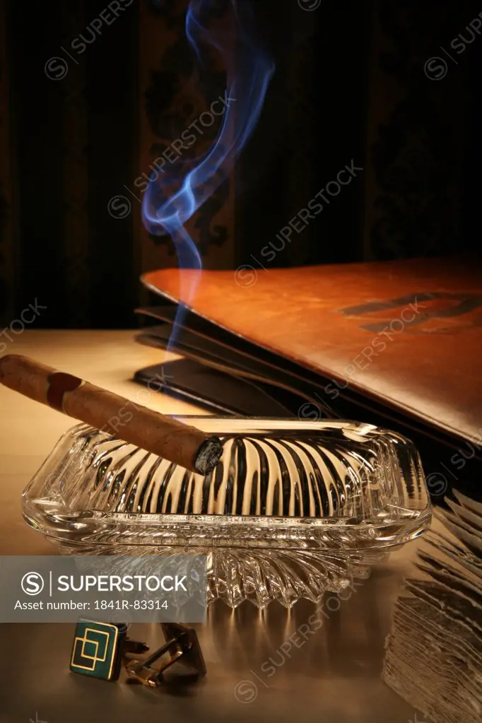 Unlit cigar in ashtray on a bedside table