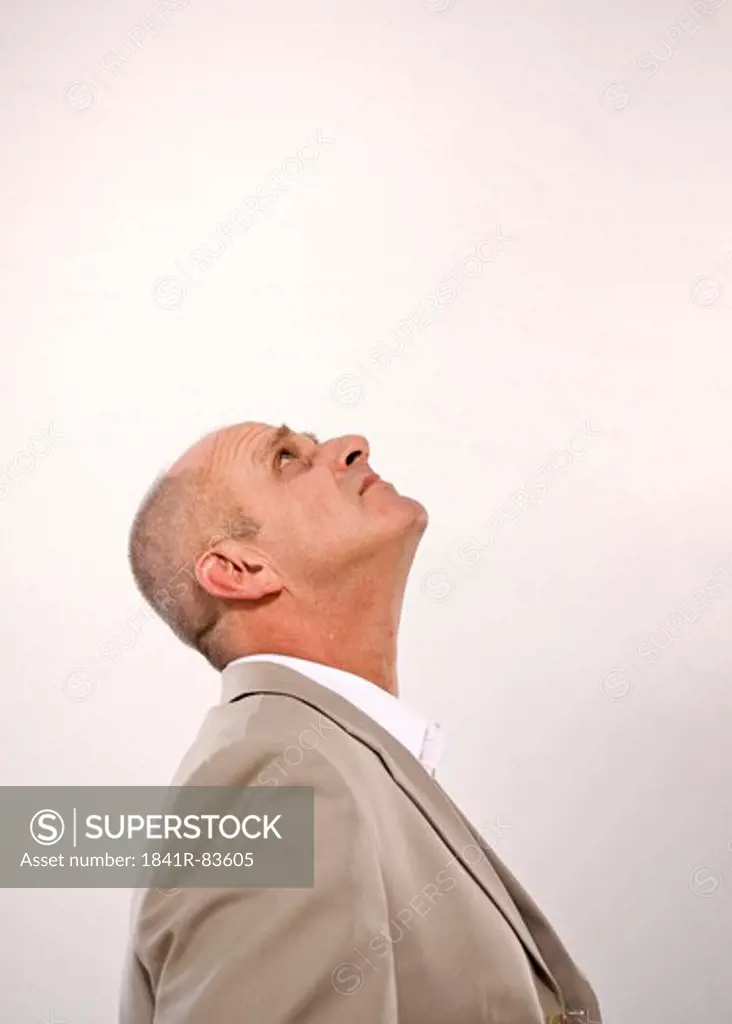 Businessman looking up, side view