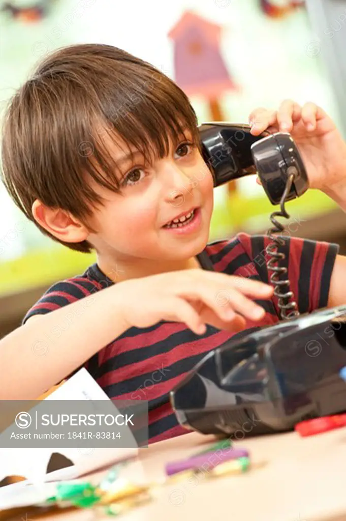 Young boy with toy phone, low angle view