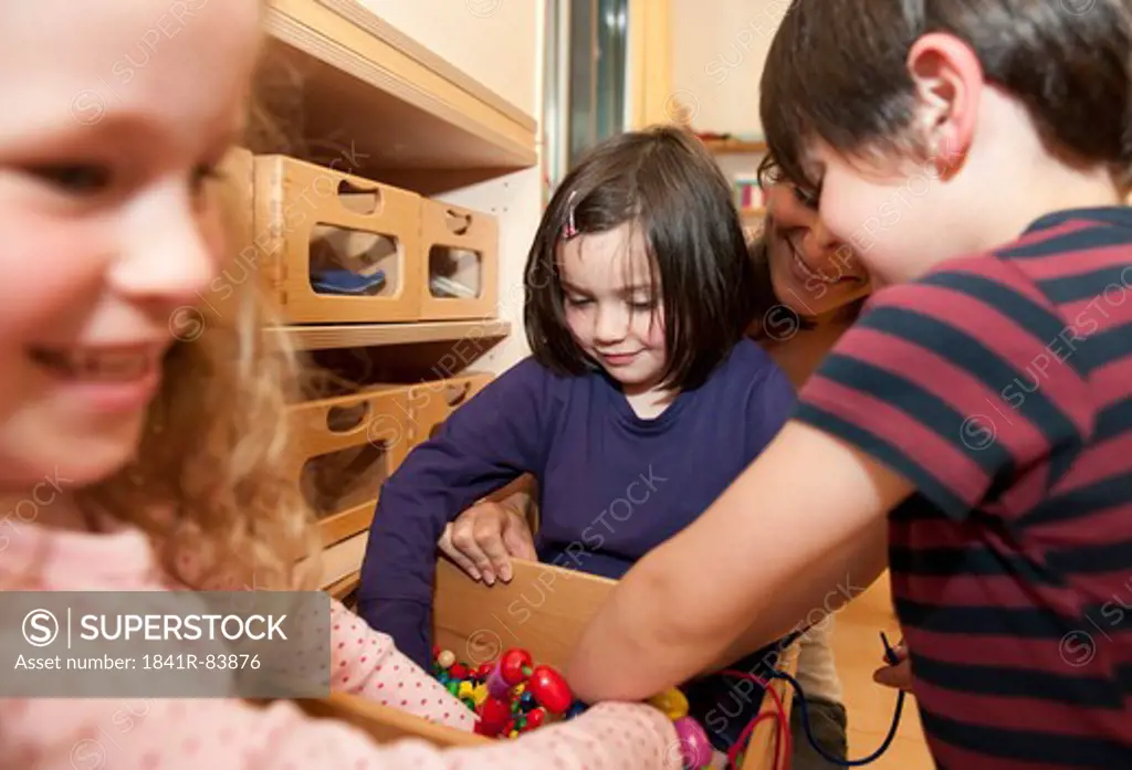 Children taking toys out of a box