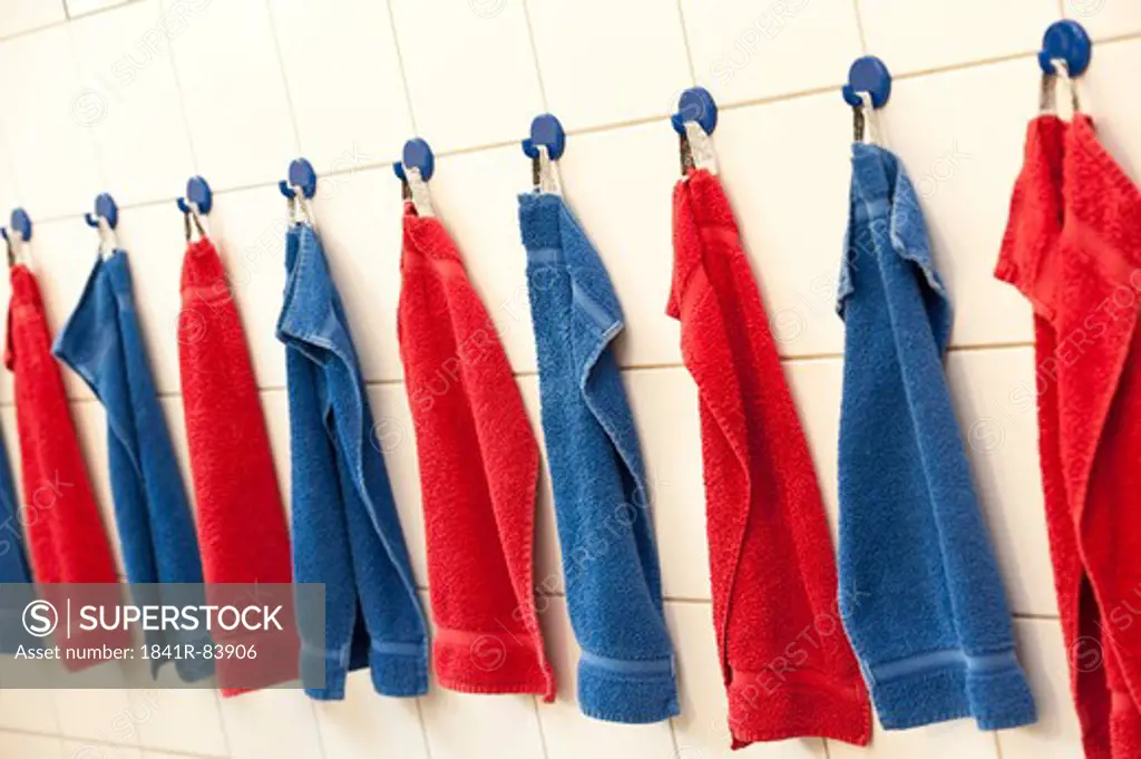 Towels hanging in a row on the wall