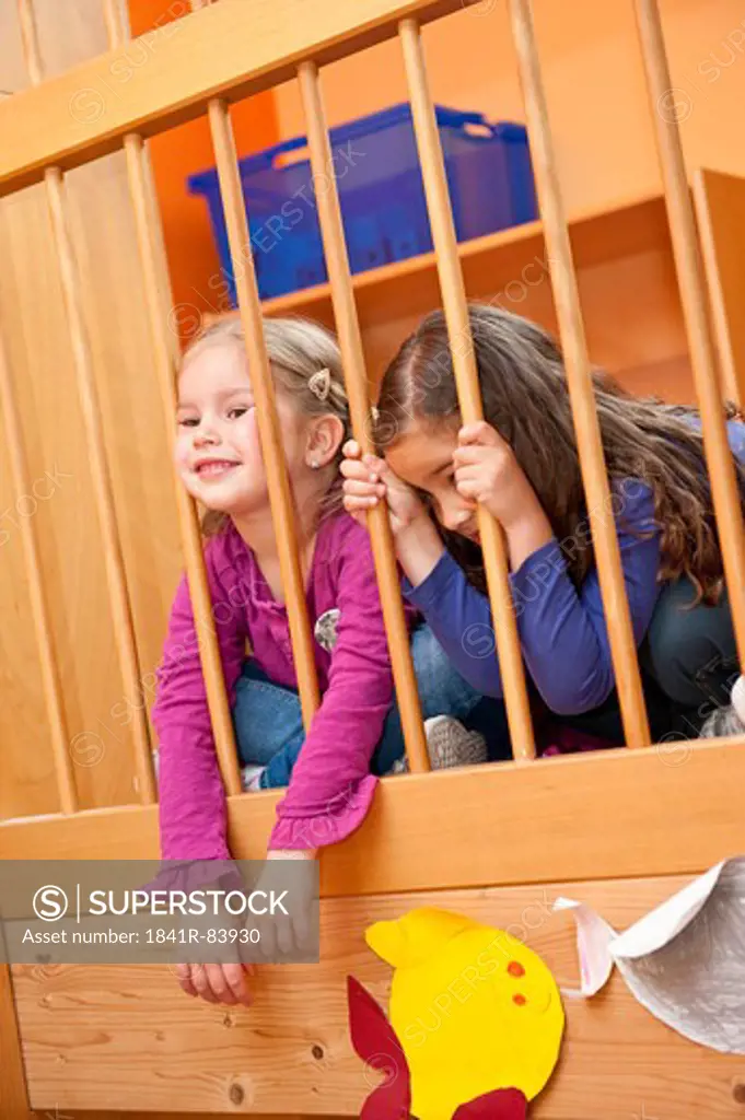 Young girls sitting behing a railing