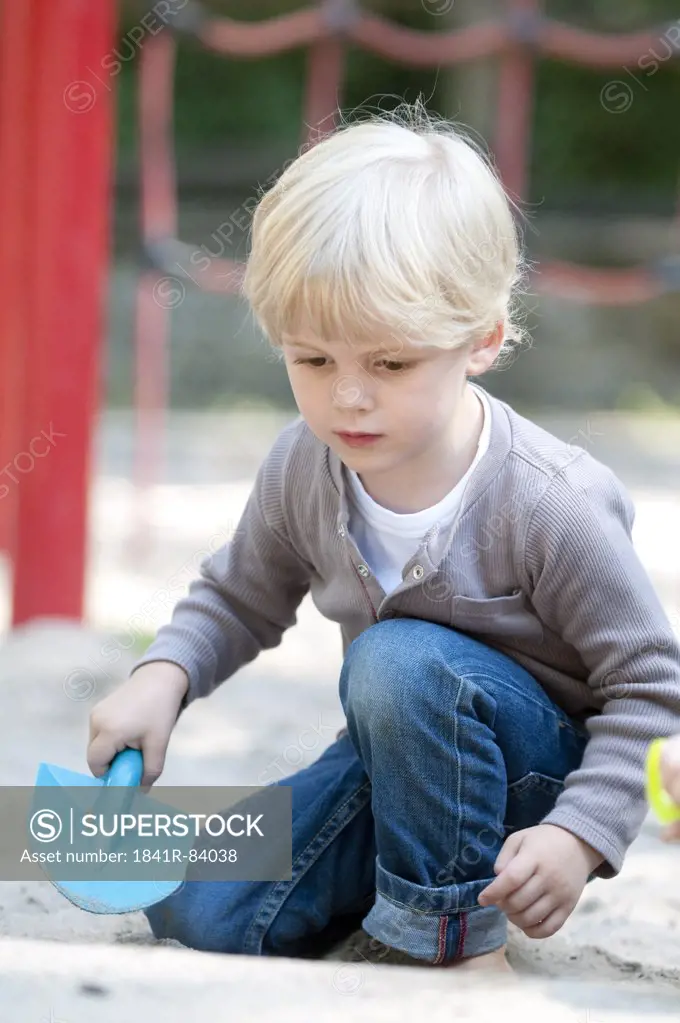 Blond boy playing on playground