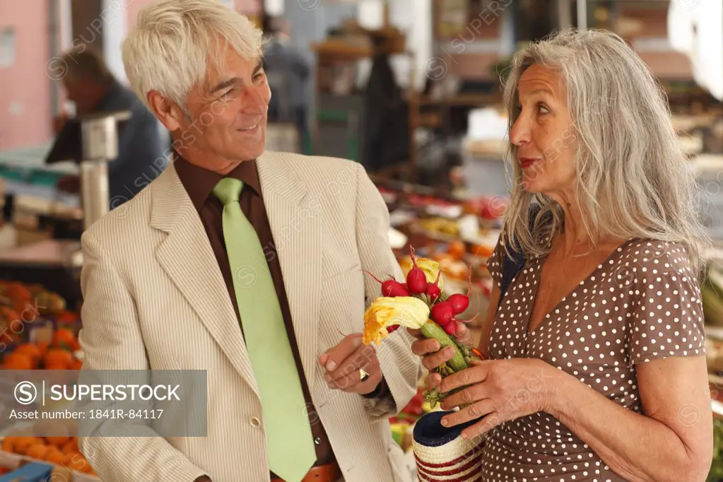 Senior couple on a vegetable market, Italy