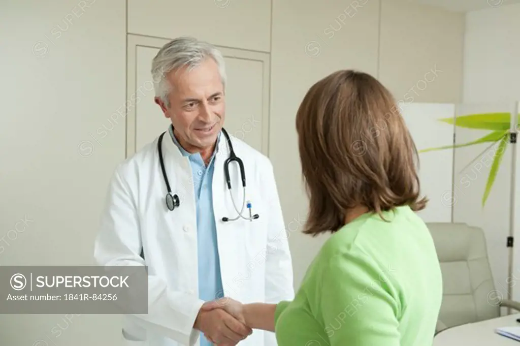 Doctor and female patient shaking hands