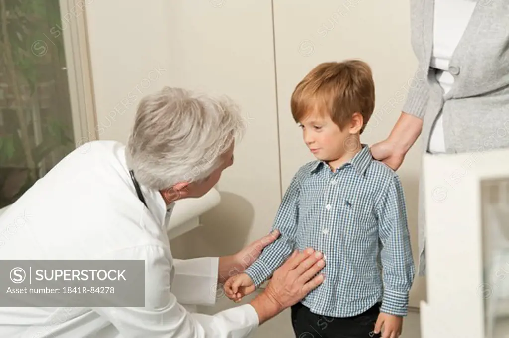 Doctor examining boy