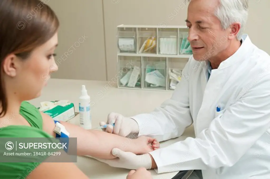 Doctor taking patient's blood sample
