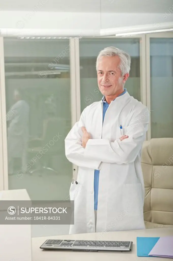 Doctor standing behind desk