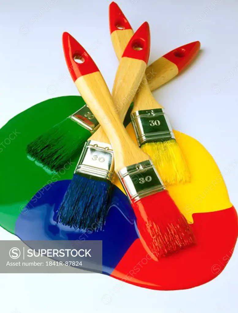 Close-up of four paintbrushes in paint