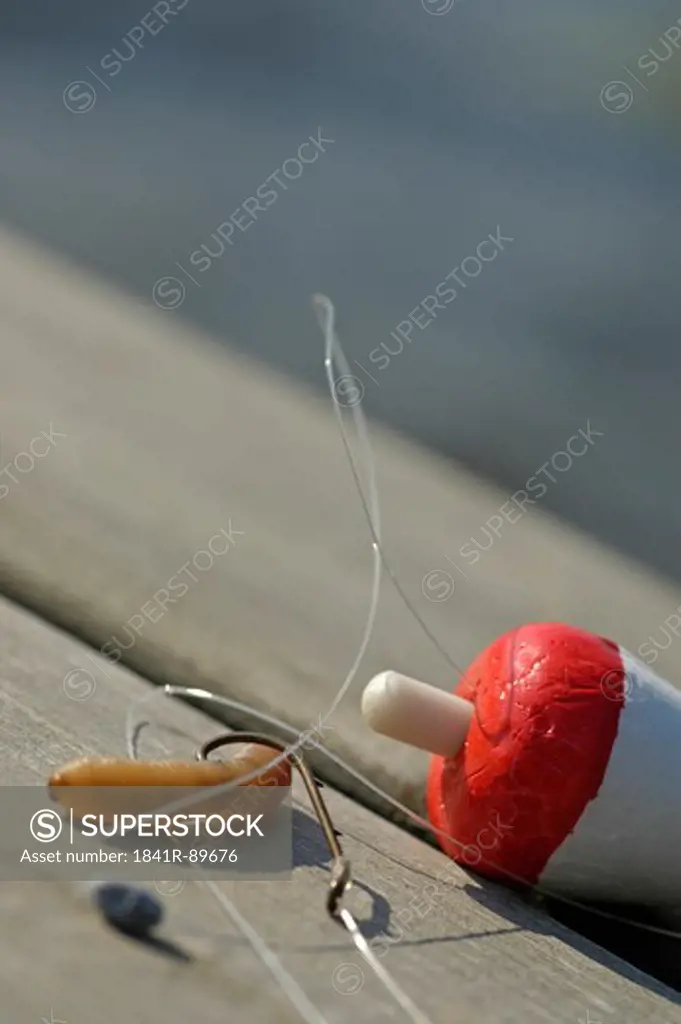 Close-up of fishing equipment on wooden plank