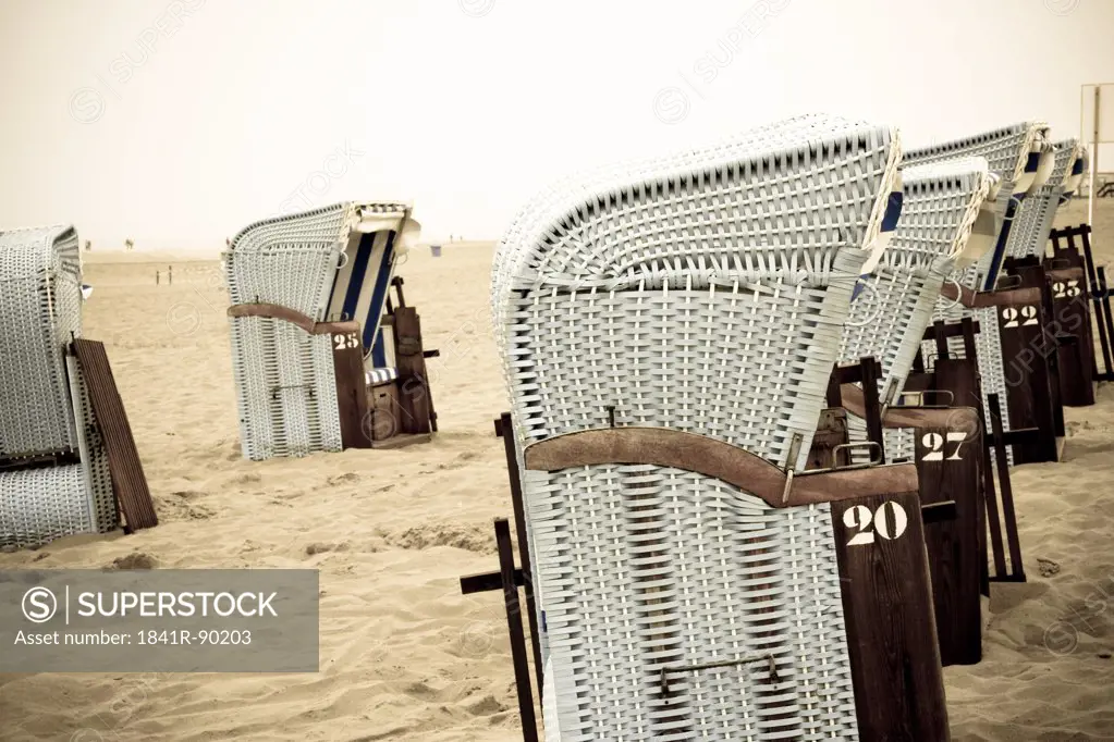 Wicker beach chairs on beach