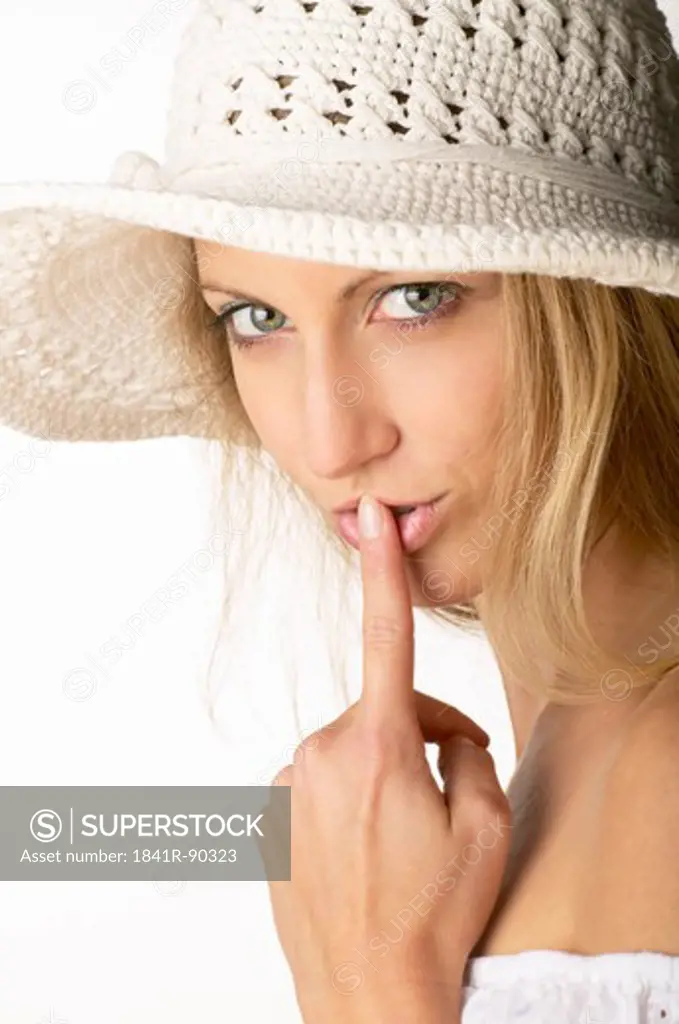 Portrait of woman with finger on her lips