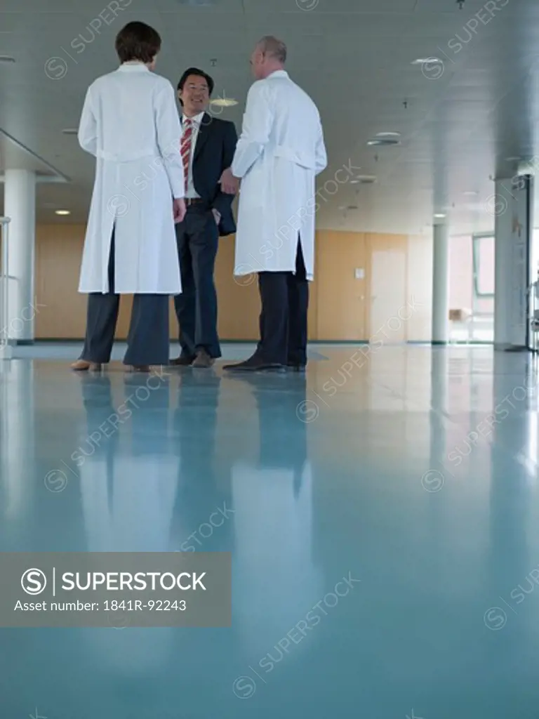 Two doctors discussing with businessman