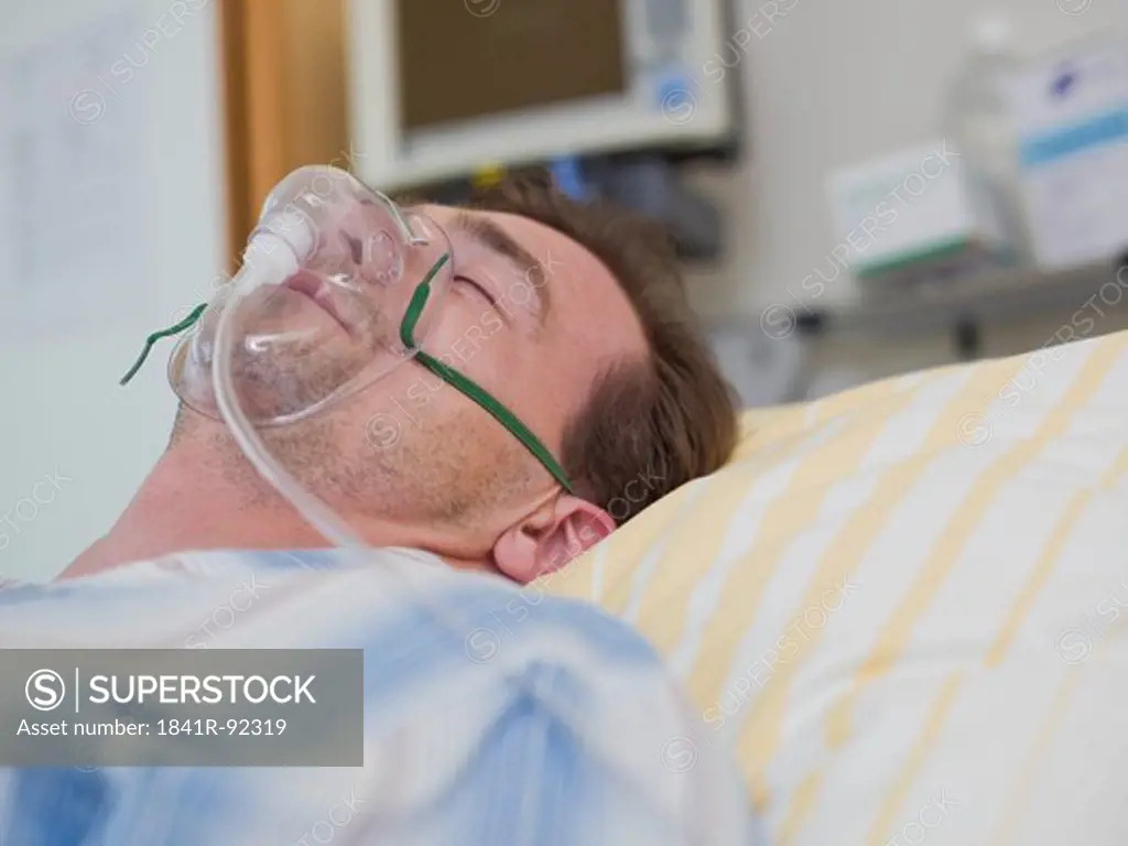 Patient wearing oxygen mask in hospital