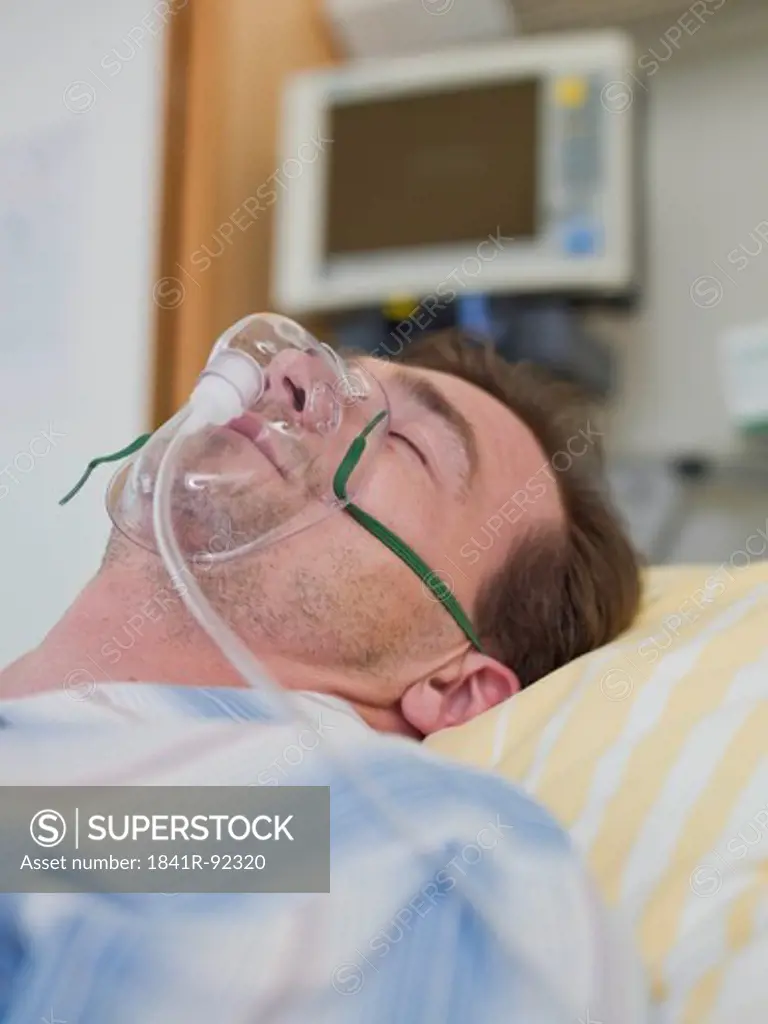 Patient wearing oxygen mask in hospital