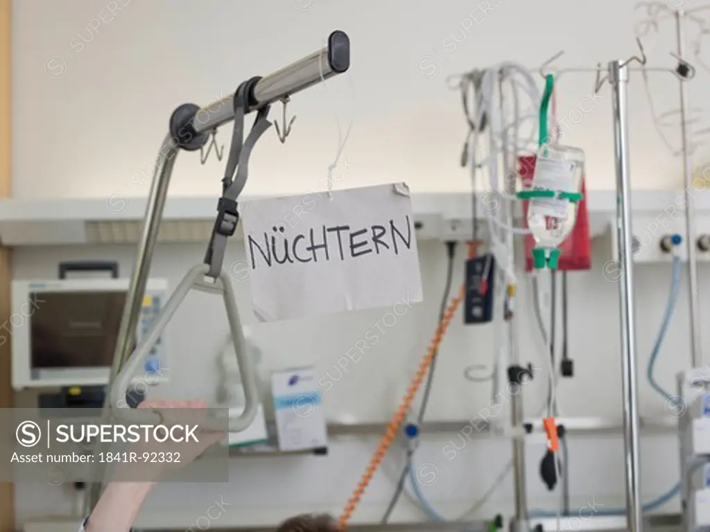 Placard hanging on patient's bed in hospital