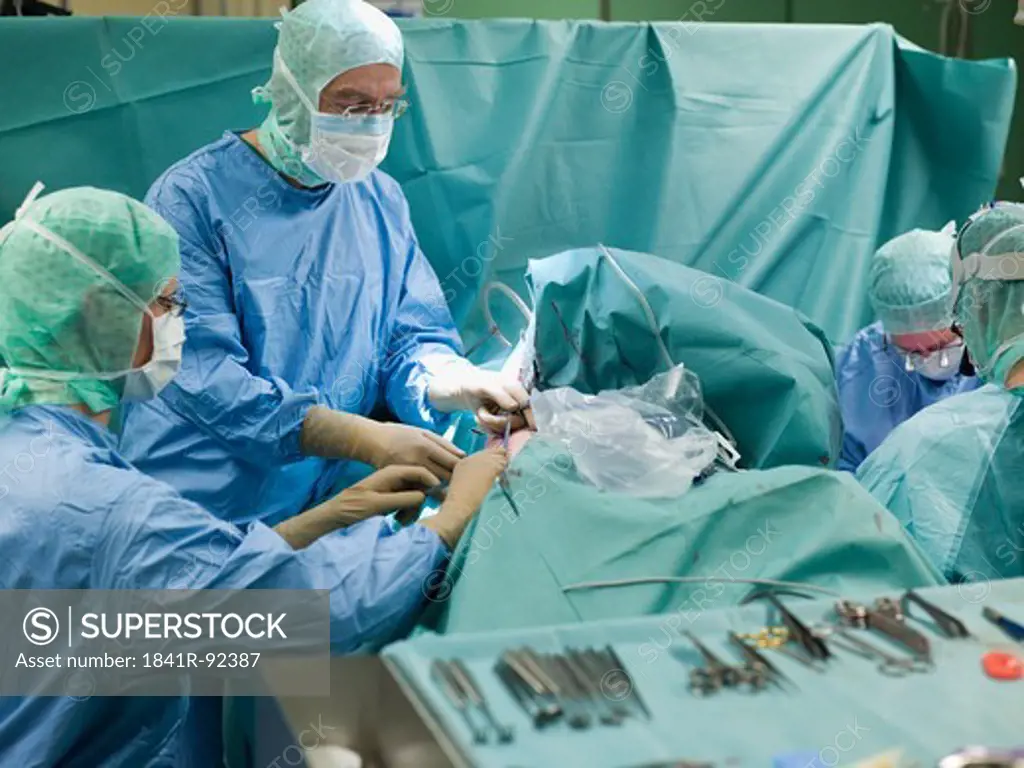 Surgeons performing operation in operating room