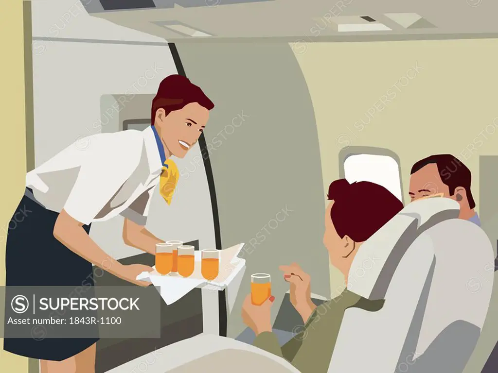 Flight attendant serving drinks to passengers in aeroplane