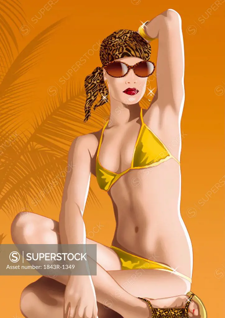 Young woman posing cross-legged in a tropical setting