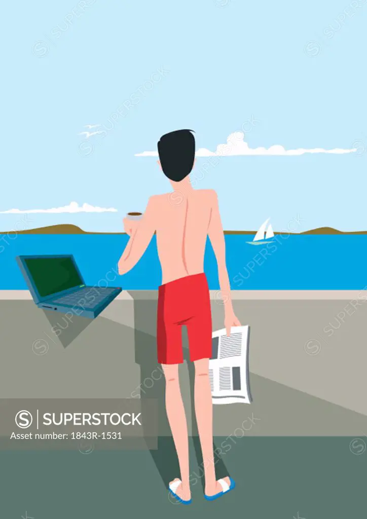 Man looking at sea view with laptop