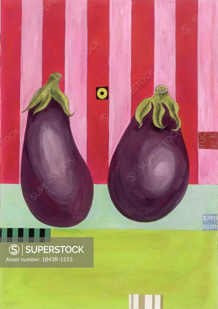 Two whole eggplants next to each other