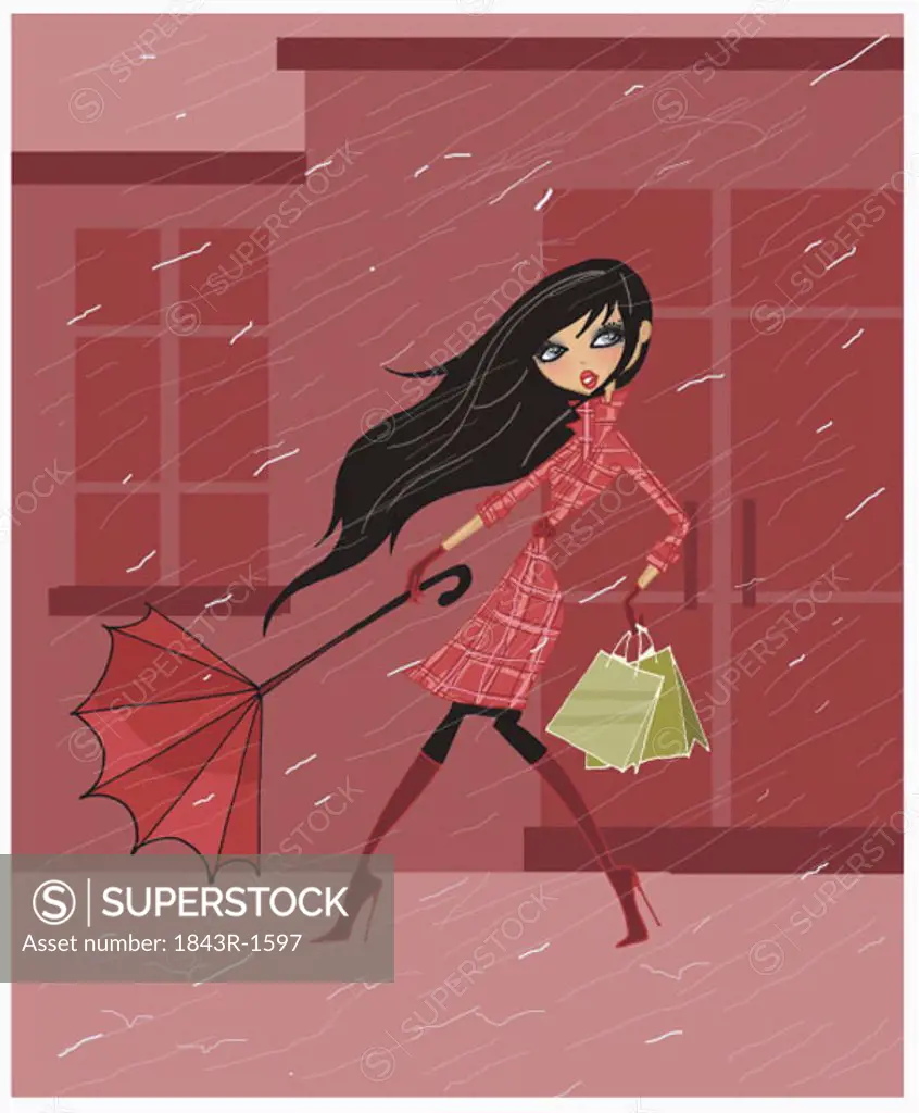 Woman holding onto her umbrella in a rainstorm