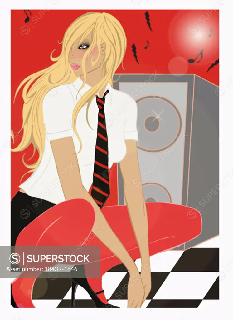 Blonde woman crouching by stereo speaker