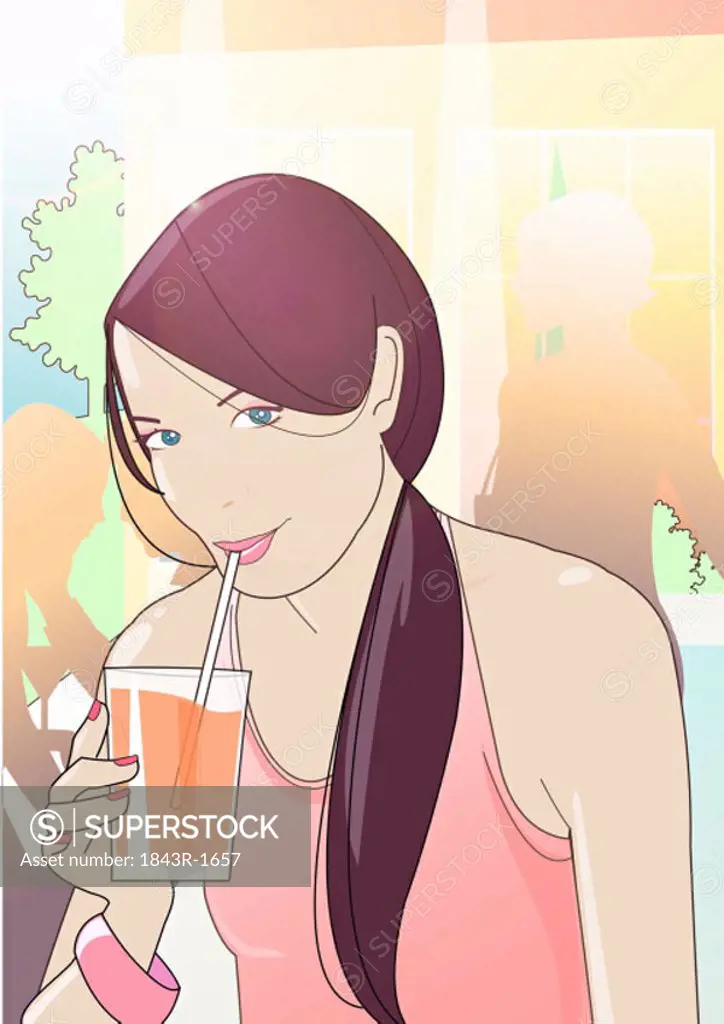Young woman sipping her drink through a straw