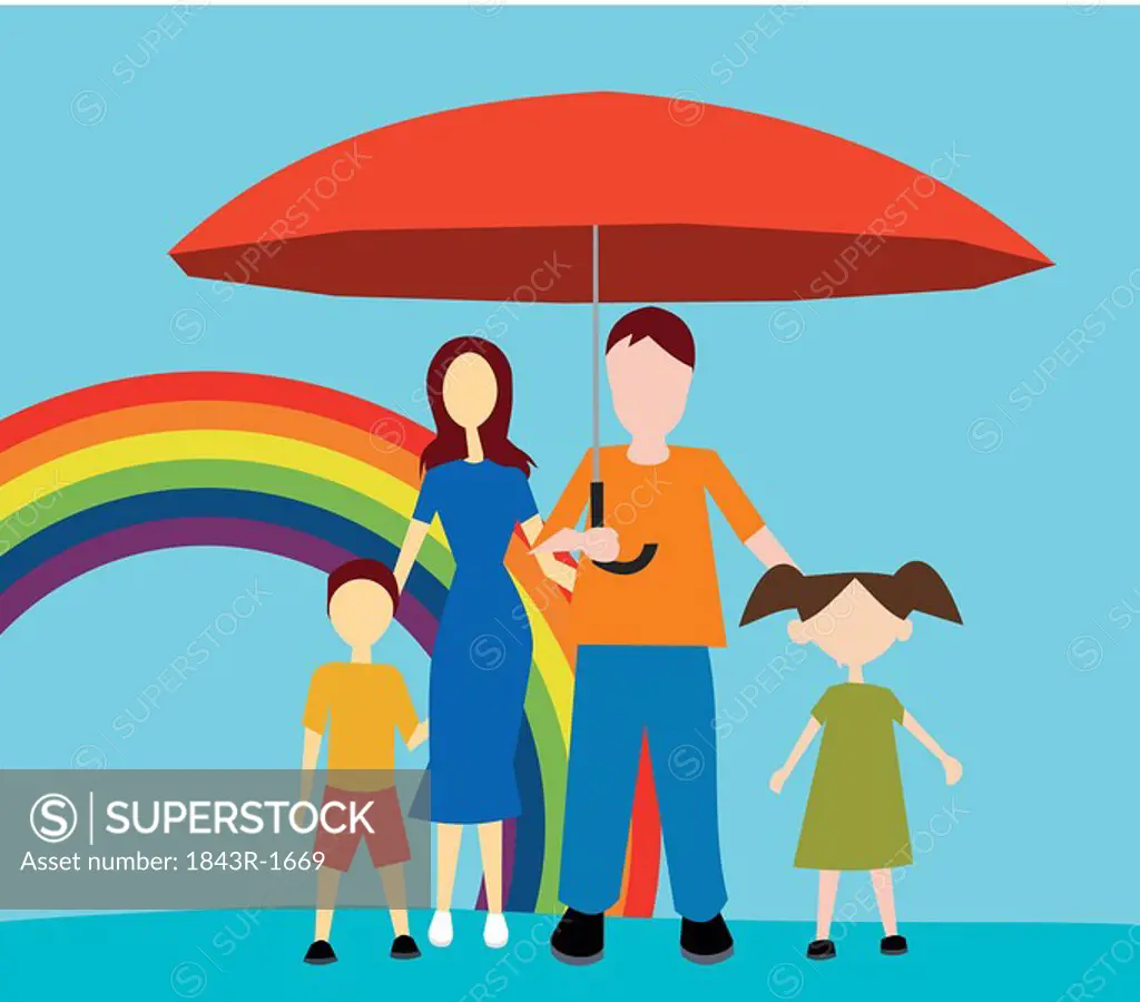 Front view of family standing with umbrella