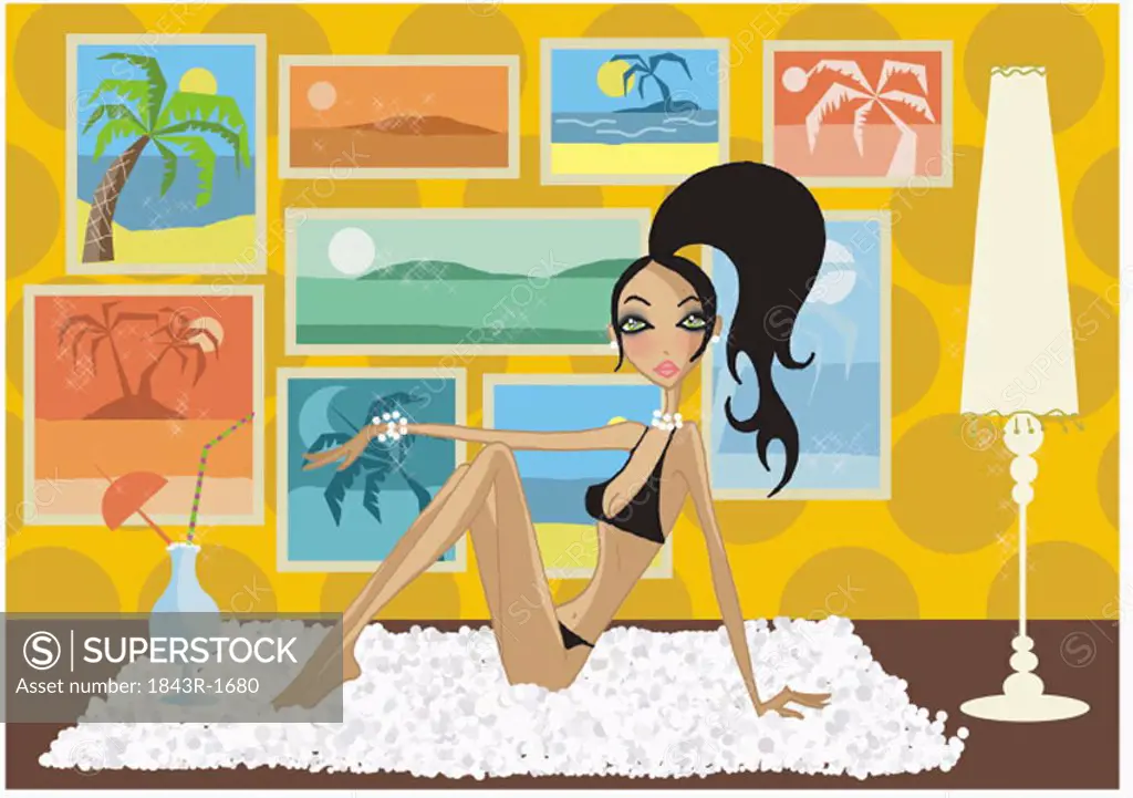 Woman in bikini on floor with vacation scenes on her wall
