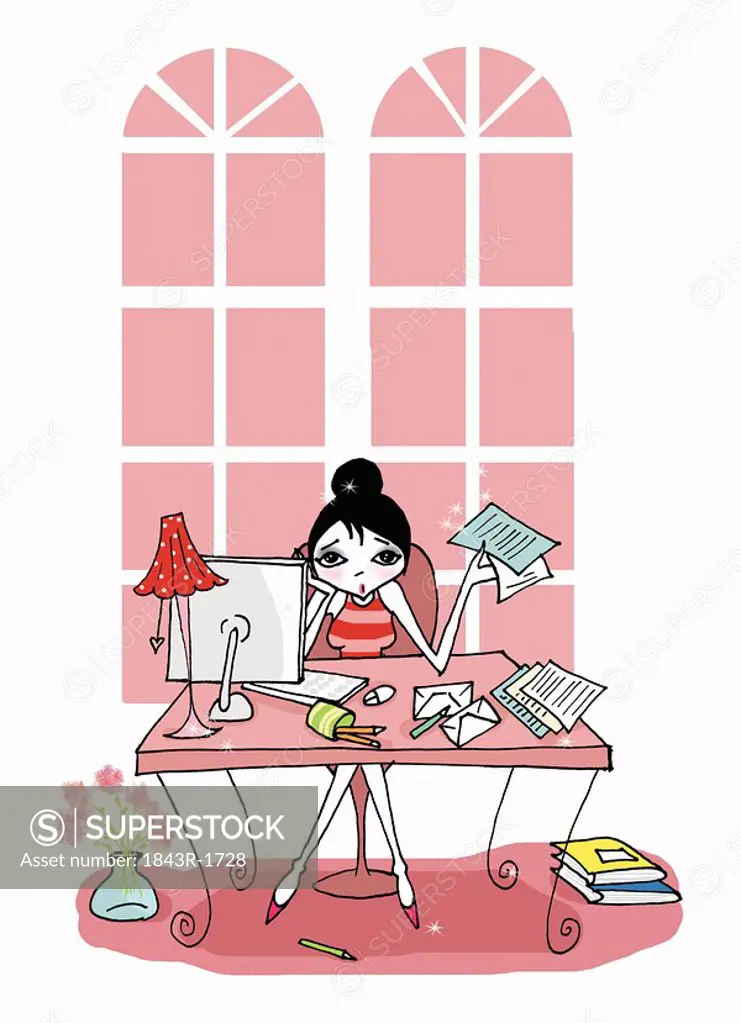 Young woman at desk with paperwork