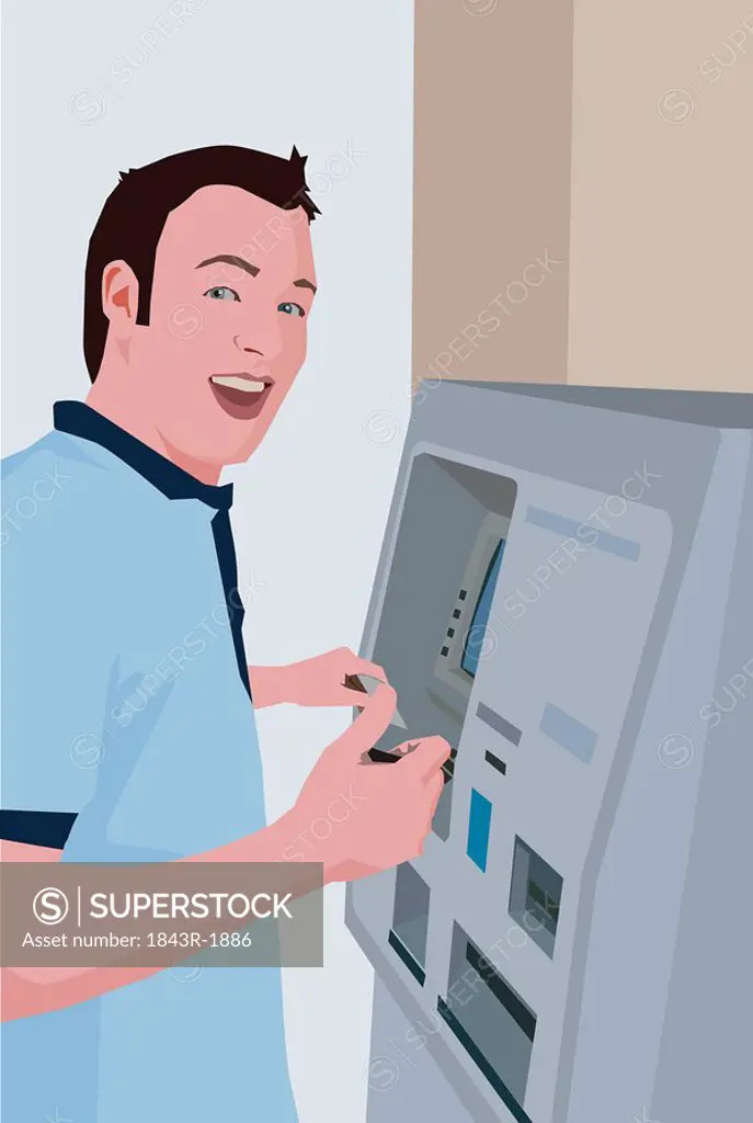 Young man using an ATM machine