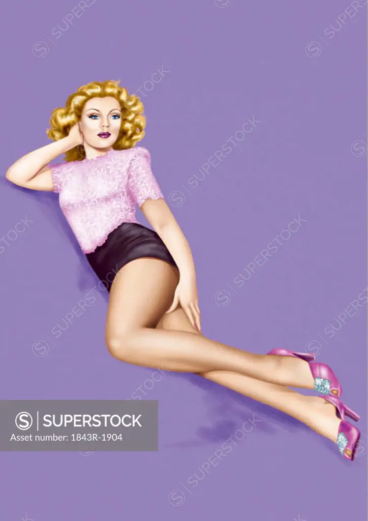 Blonde pinup girl in high heels lying suggestively on the ground