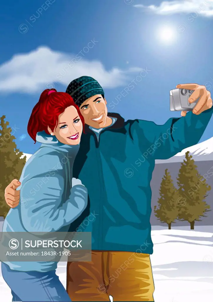 Couple photographing themselves in a winter landscape