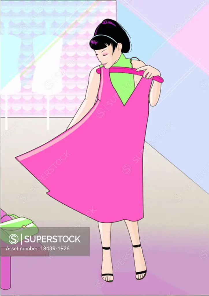 Young woman trying out a pink dress in a store