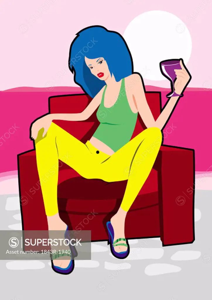 Cool young woman posing on an armchair with a drink