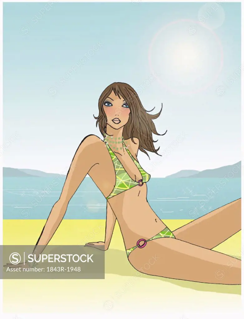 Brunette sitting on beach posing in her bikini