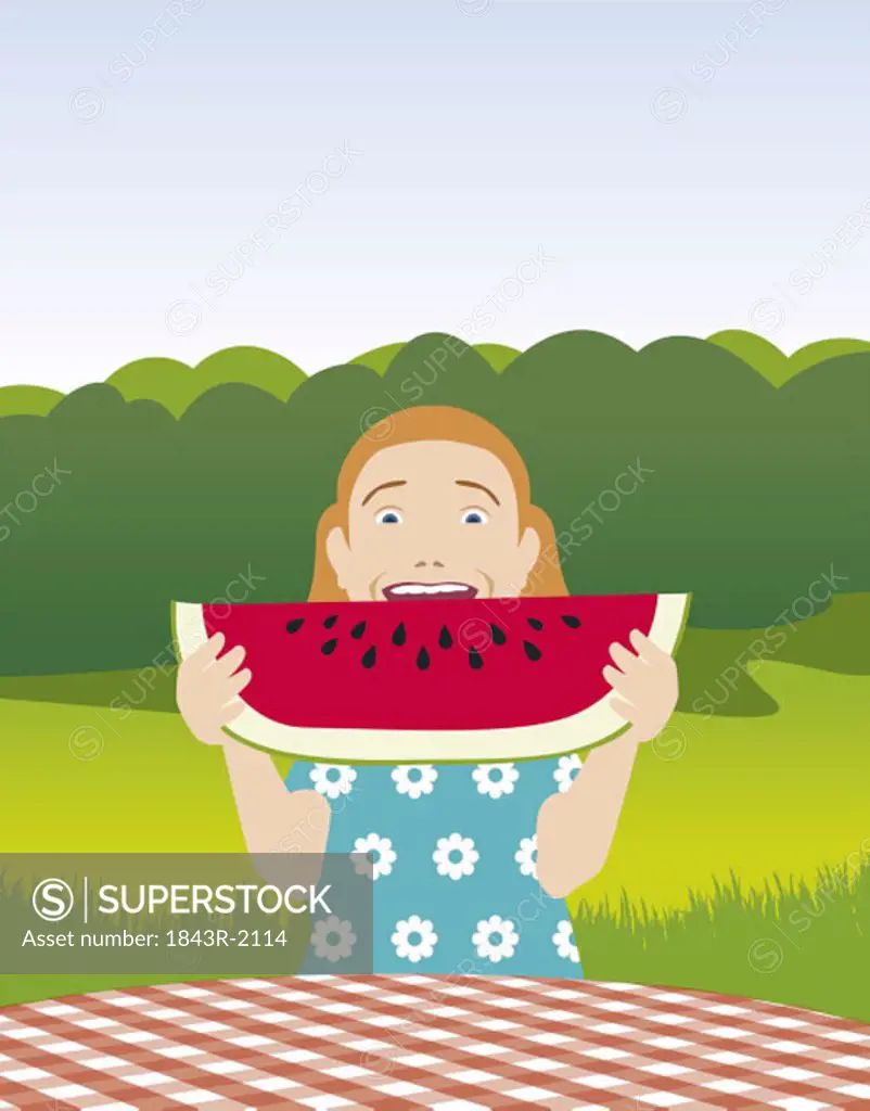 Girl biting into a slice of watermelon
