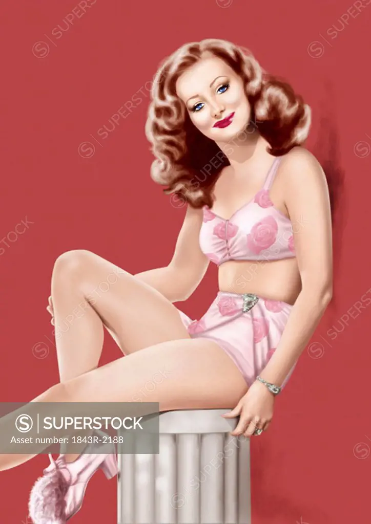 Pinup girl in pink flowery lingerie posing on column