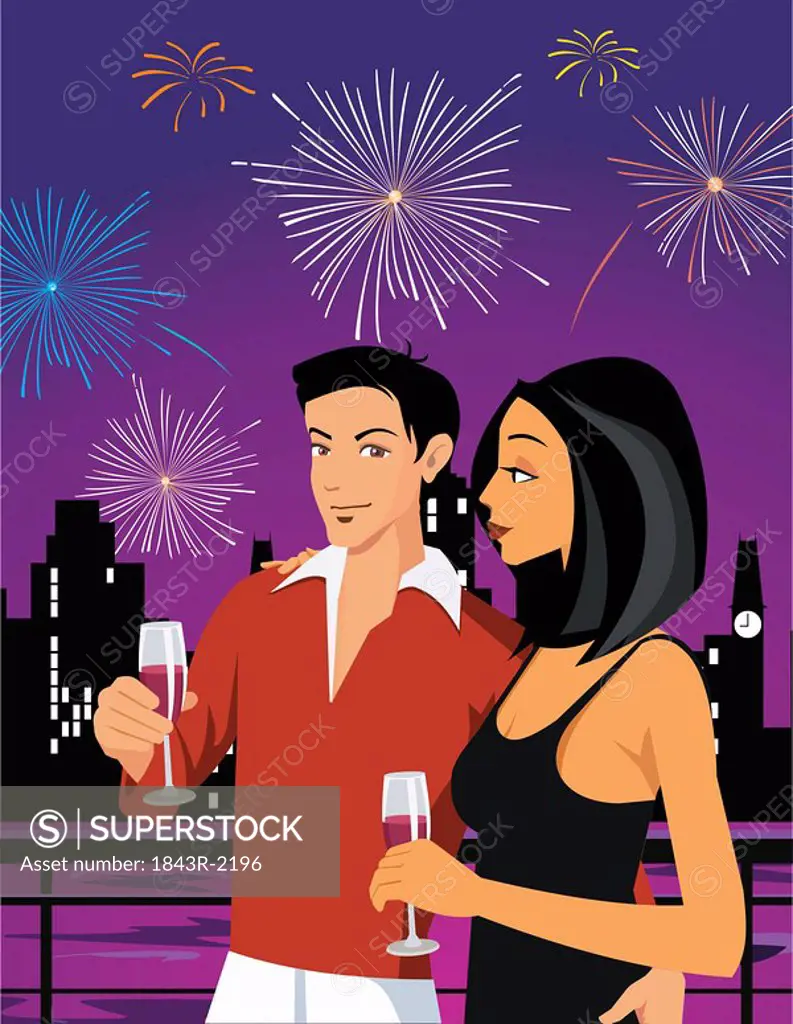 Couple enjoying drink and firework display in the sky