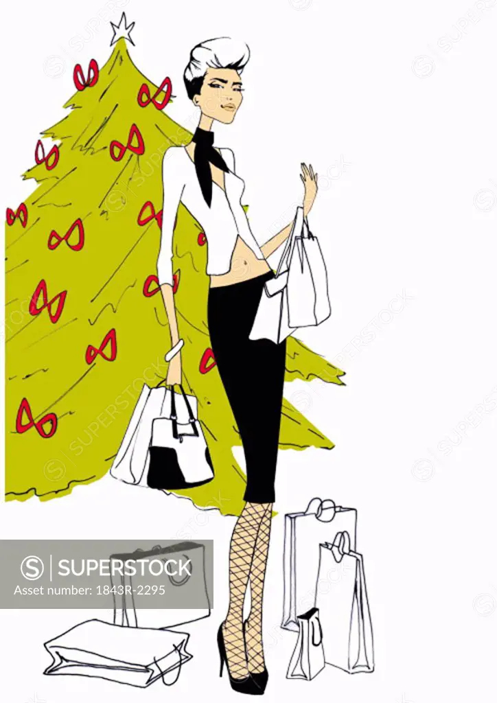 Fashionable woman with shopping bags in front of Christmas tree