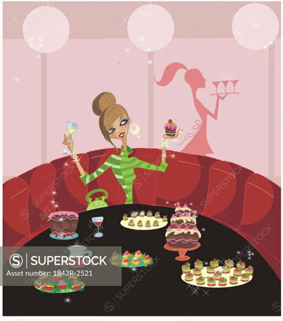 Young woman celebrating alone with a table full of sweets