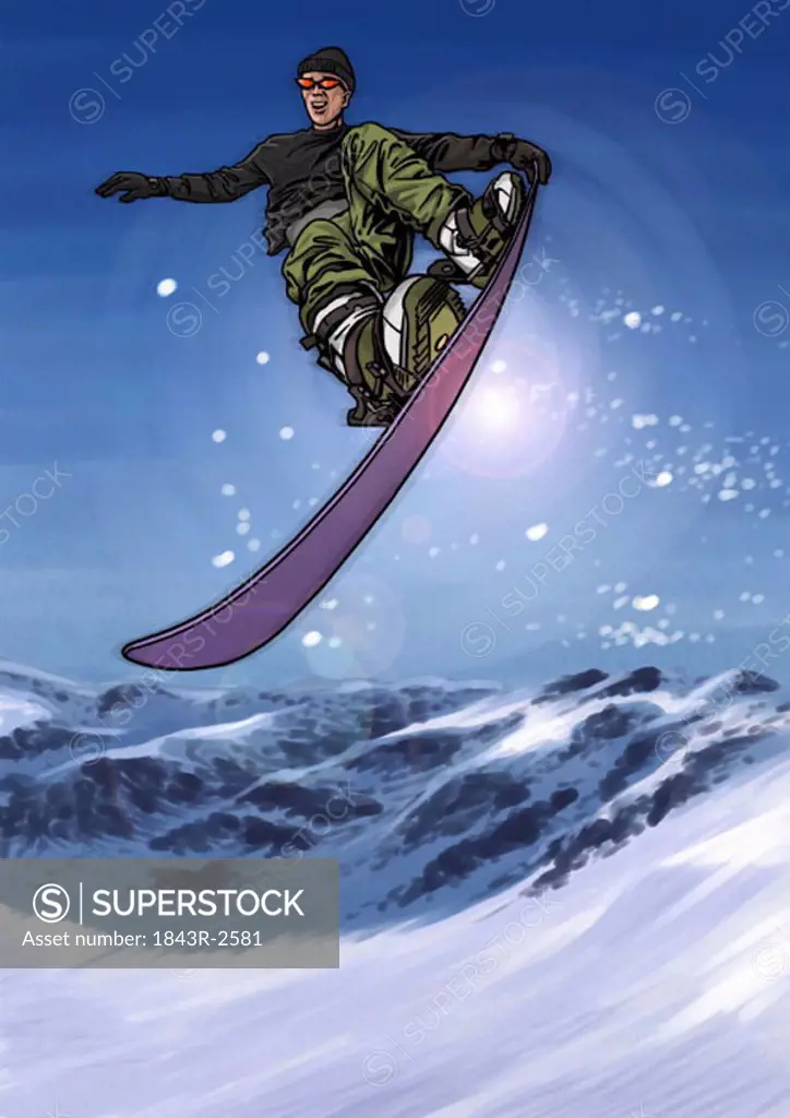 Young man jumping through the air on his snowboard