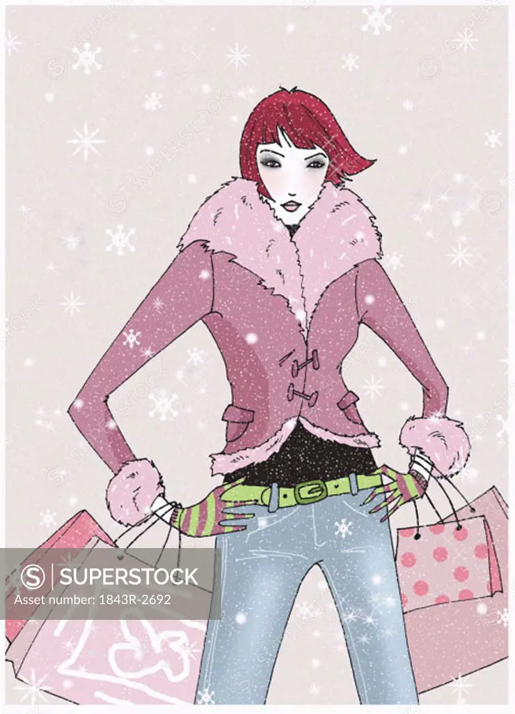 Young woman posing in the snow with shopping bags